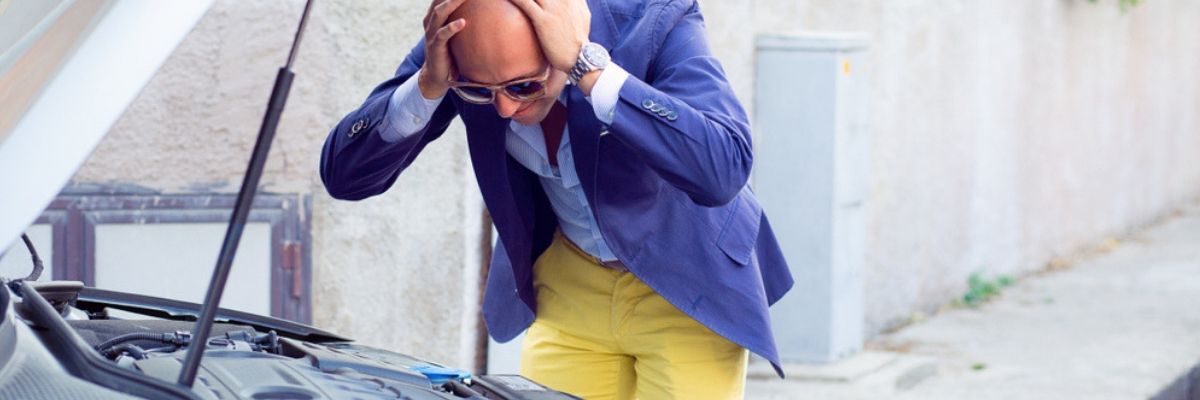 Bald man in yellow pants and a purple jacket panicking at the results of his used car inspection.