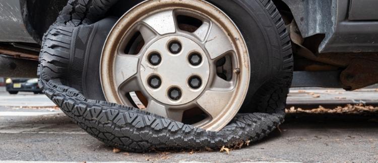 A photographed tire blowout with a collapsed bottom wheel.