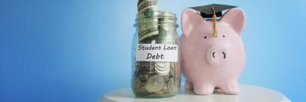 A piggybank wearing a grad cap beside a jar filled with student loan debt savings.