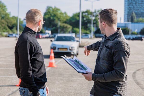 Driver training taking place in a parking lot to lower car insurance